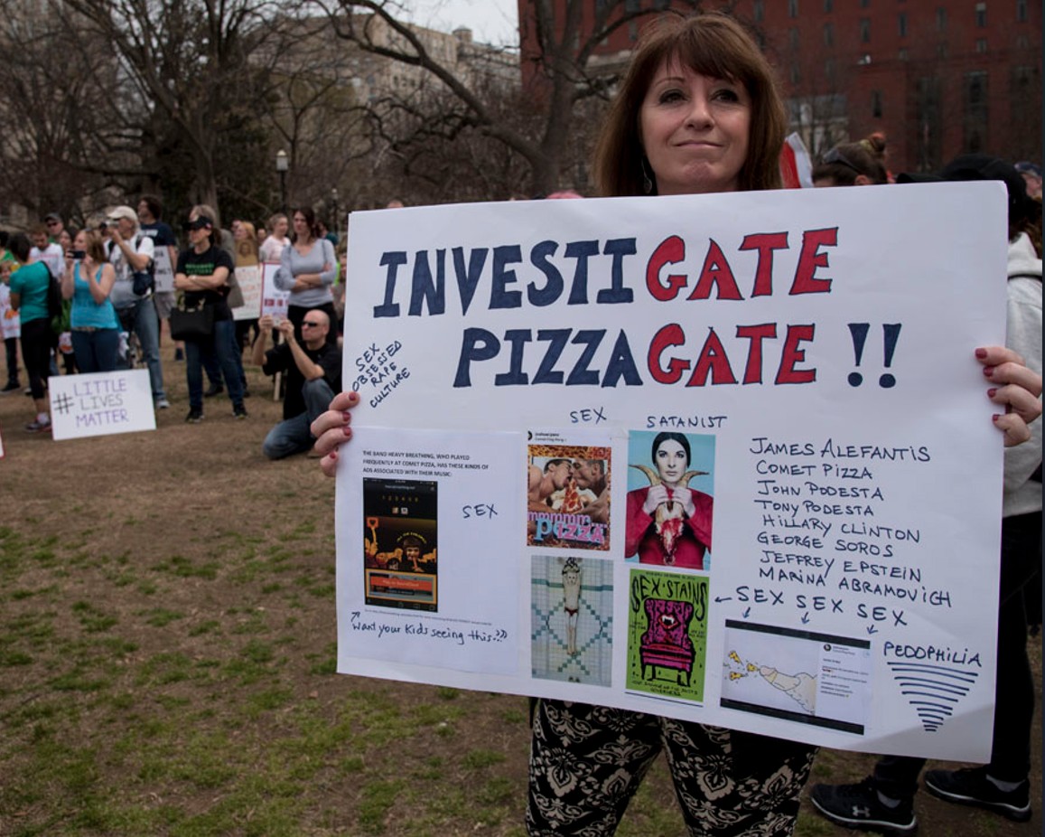 Investigate Pizzagate. From a rally in the Washington, D.C., area back in 2017. Picture by Blink O'Fanaye @ www.flickr.com/photos/blinkofanaye/33496659362/