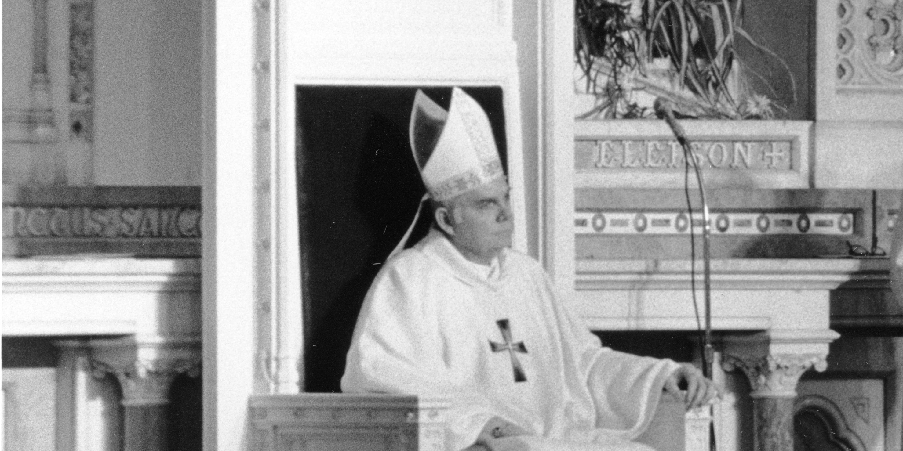 Archbishop, future Cardinal, Bernard Law in a picture from 1984, at the Boston Cathedral. Picture from the Mayor Raymond L. Flynn records, City of Boston @ www.flickr.com/photos/48039697@N05/9617962158. 