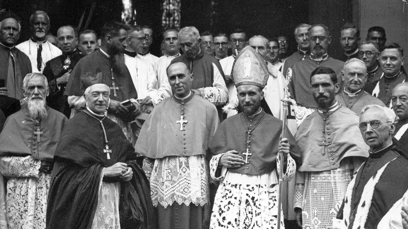 Third from left to right in the first row, the then-priest Marcel Lefebvre about to be consecrated as bishop in Dakar, Senegal, at the time a territory in the French Empire, September 18, 1947. Wikimedia @ www.commons.wikimedia.org/w/index.php?curid=75244858