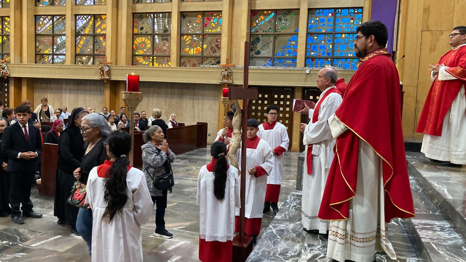 Wearing only a red liturgical stole and standing directly behind the Holy Cross, José Guadalupe Torres Campos, bishop of Ciudad Juárez, presides over the Good Friday service. Image shared by his diocese's social media on April 3, 2026. 