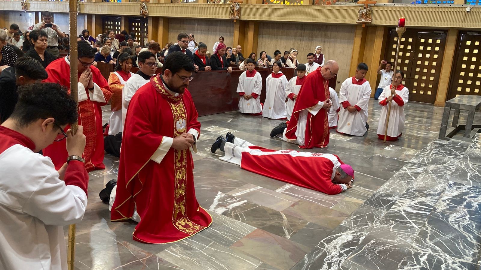 Prostrating himself on the floor, José Guadalupe Torres Campos, bishop of Ciudad Juárez, Chihuahua, assumes the 