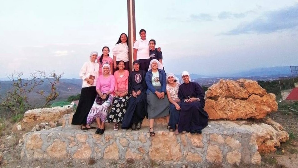 A group of ten candidates to religious life at different stages in their development and a nun at the atrial cross marking the entrance to the monastery compound in Berriozábal, Chiapas. Picture published on May 26, 2020, by FRICYDIM's social media. 