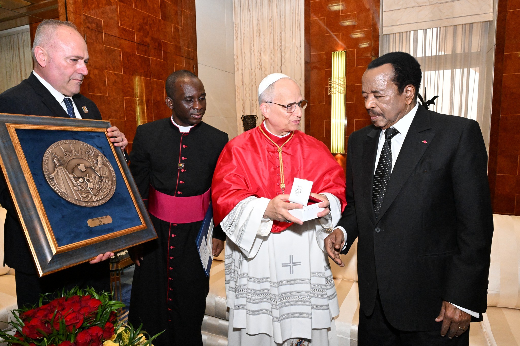 At center, Pope Leo XIV gifts a religious medal to Paul Biya, President of Cameroon, April 15, 2026. From the Facebook profile of the Presidency of Cameroon. 