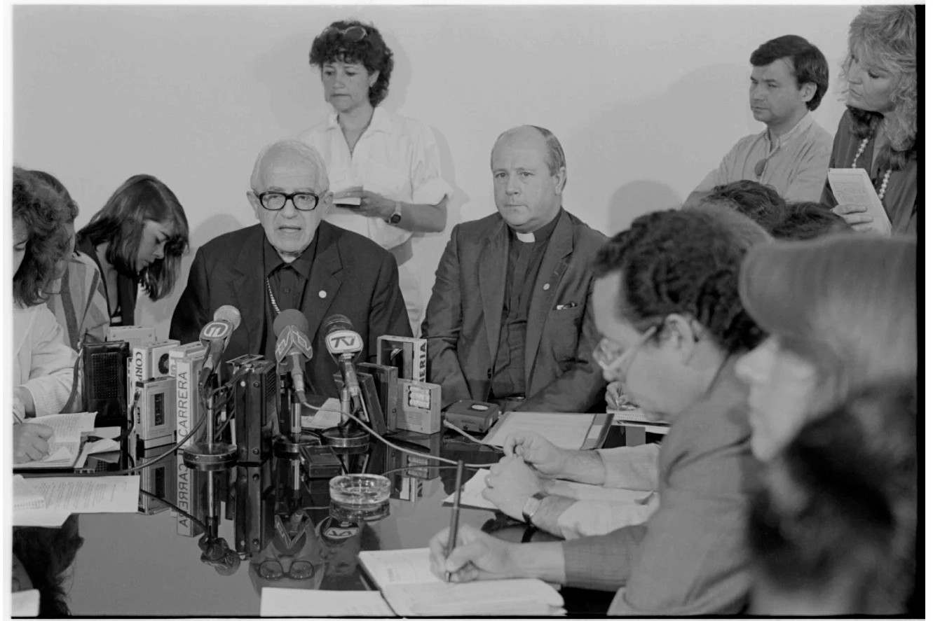 At center, wearing glasses then archbishop of La Serena and president of the Conference of Catholic Bishops of Chile, Bernardino Piñera Carvallo. In Roman collar, to the right, then coadjutor bishop of La Serena Francisco José Cox Huneeus, in a 1989 picture by Inés Paulino. National Library of Chile @ www.bibliotecanacionaldigital.gob.cl/bnd/629/w3-article-636841.html. At center, wearing glasses then archbishop of La Serena and president of the Conference of Catholic Bishops of Chile, Bernardino Piñera Carvallo. In Roman collar, to the right, then coadjutor bishop of La Serena Francisco José Cox Huneeus, in a 1989 picture by Inés Paulino. National Library of Chile @ www.bibliotecanacionaldigital.gob.cl/bnd/629/w3-article-636841.html.