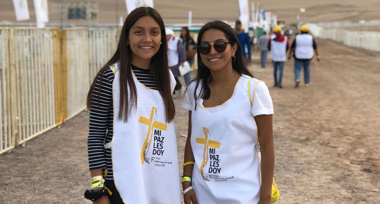 Two volunteers after one of Pope Francis's public activities during his January 2018 trip to Chile. Notice the aprons with the white and yellow colors. Opus Dei social media. Two volunteers after one of Pope Francis's public activities during his January 2018 trip to Chile. Notice the aprons with the white and yellow colors. Opus Dei social media.