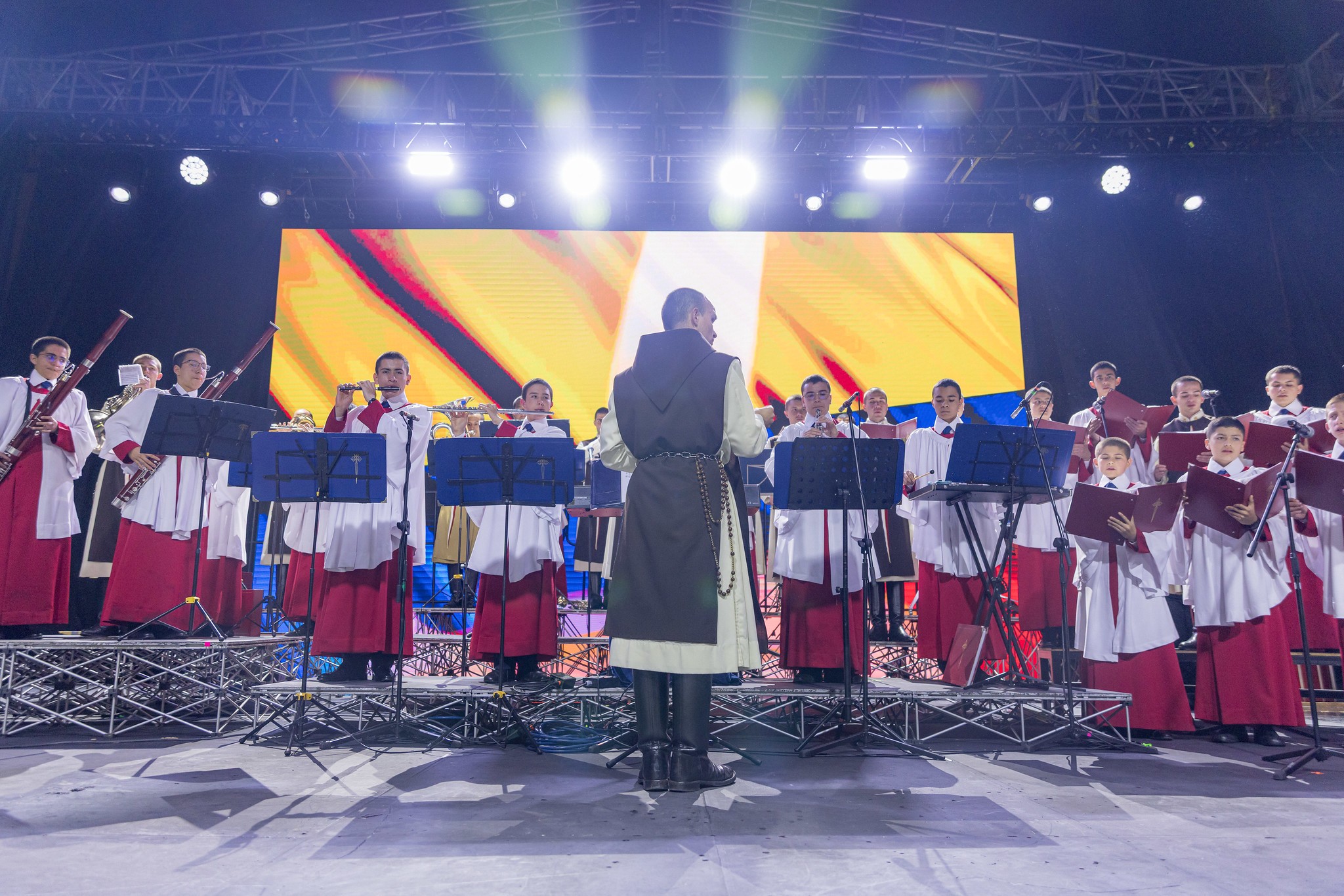 Wearing the full habit of the Heralds of the Gospel, military boots included, the director of the choir and orchestra leads them while playing a song during the vigil at Bolívar Square in Bogotá, August 28, 2026.Picture by the Presidency of Colombia @ www.flickr.com/photos/204852926@N07/55494676949/in/datetaken/ 