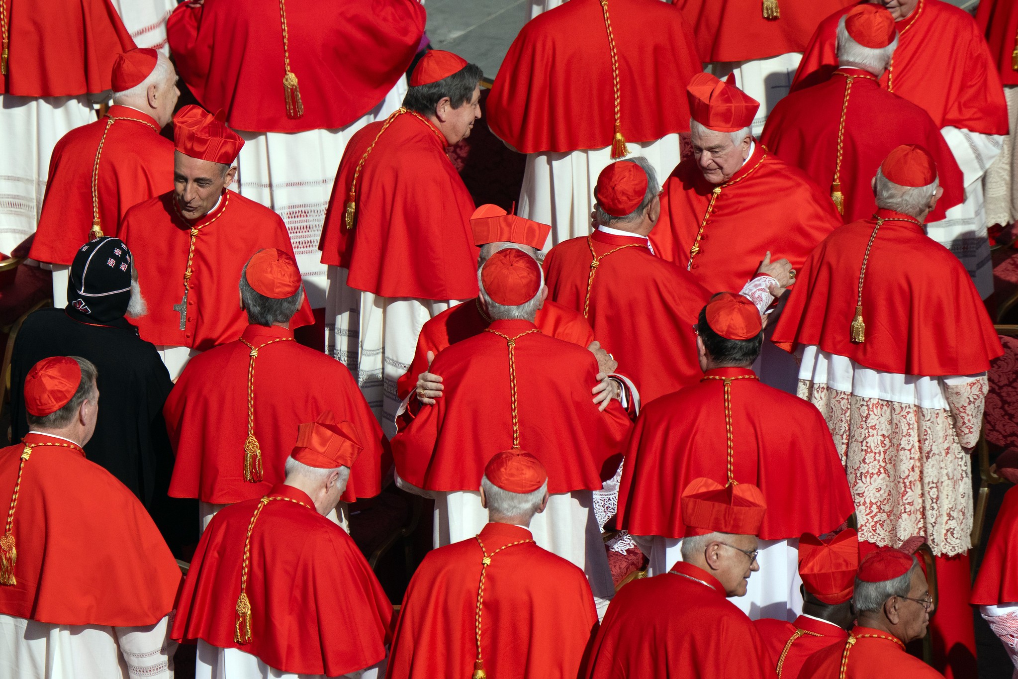 Catholic cardinals exchange greetings during the 2023 Consistory, when both Pope Leo XIV, at the time Robert Prevost, and Víctor Manuel Fernández were elevated to the College of Cardinals by Pope Francis. See final not for photo credit.